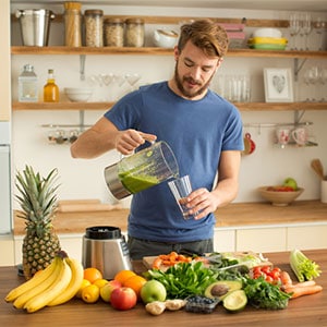 pouring green juice into glass
