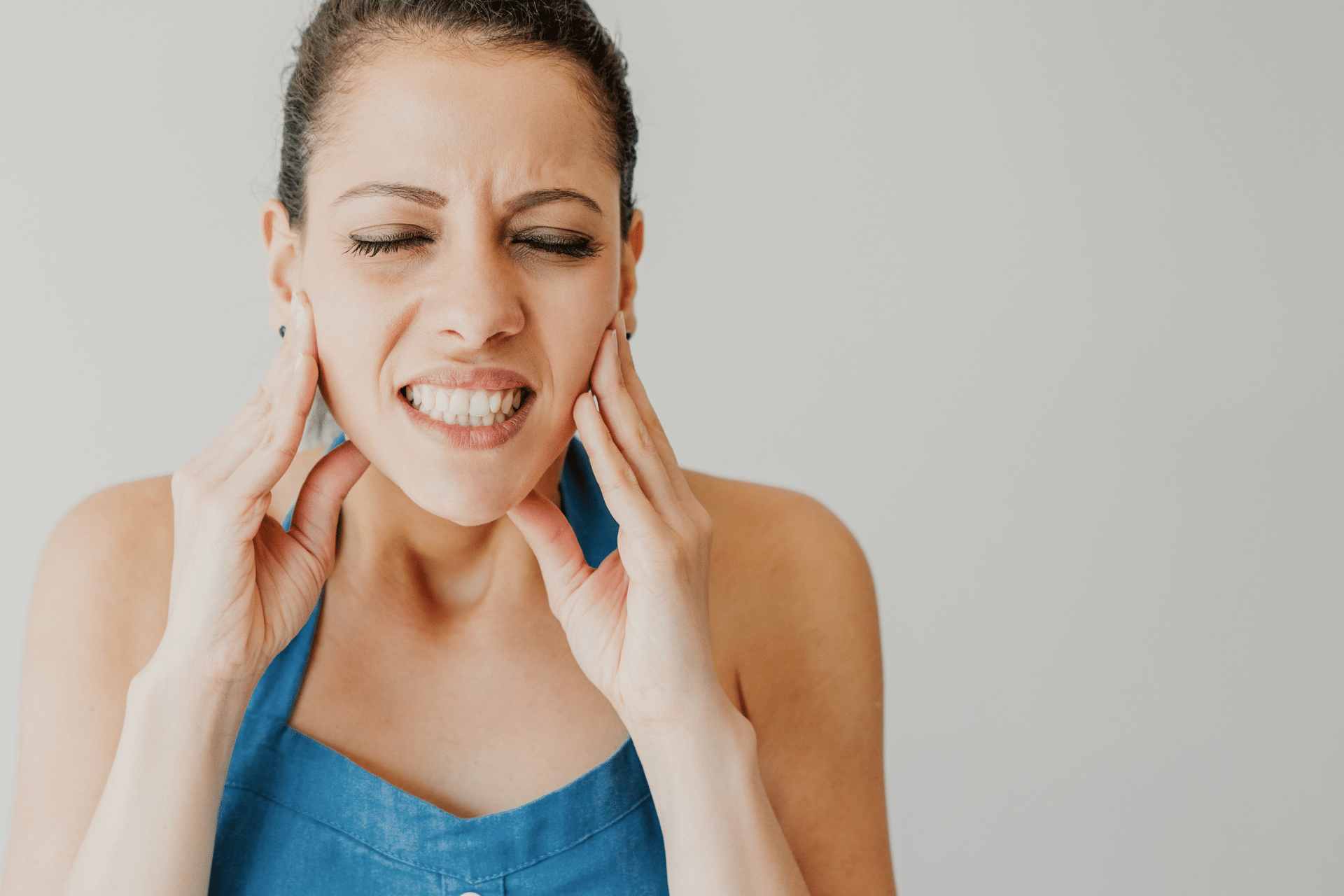 Woman experiencing jaw pain related to bite concerns in Oakwood, GA